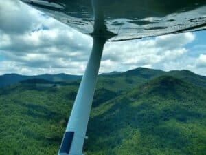 Micajah Clark Dyer Plane In Flight Near Rattlesnake Mountain